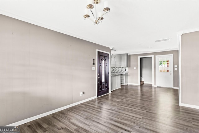 125 Sycamore Dr, Athens, GA 30606 - unfurnished living room featuring crown molding, a chandelier, and dark wood-style floors