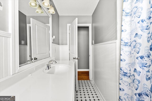 125 Sycamore Dr, Athens, GA 30606 - bathroom with a wainscoted wall, vanity, and curtained shower