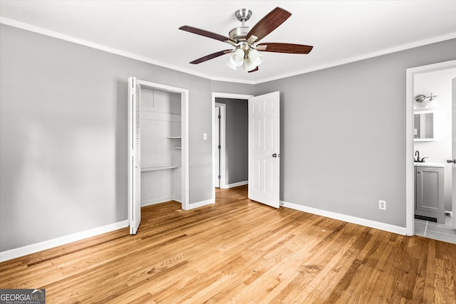 125 Sycamore Dr, Athens, GA 30606 - unfurnished bedroom with light wood-type flooring, a closet, crown molding, ensuite bathroom, and a ceiling fan
