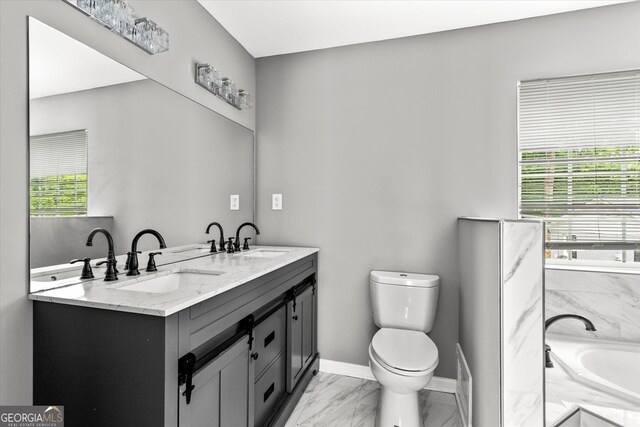 125 Sycamore Dr, Athens, GA 30606 - bathroom featuring double vanity, marble look tile flooring, and a tub with marble appearance