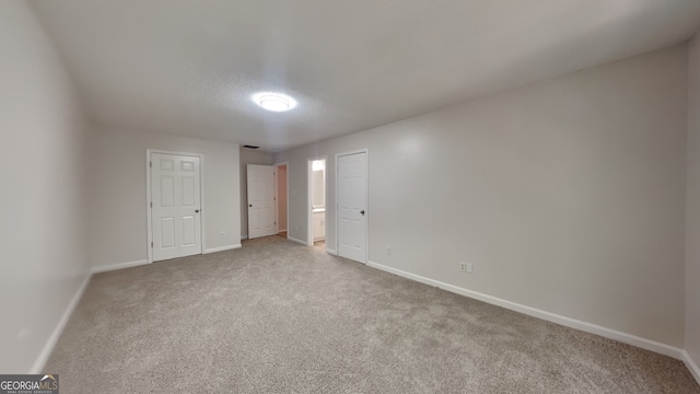 700 Patriots Point St, Locust Grove, GA 30248 - unfurnished bedroom featuring baseboards, carpet, and a textured ceiling