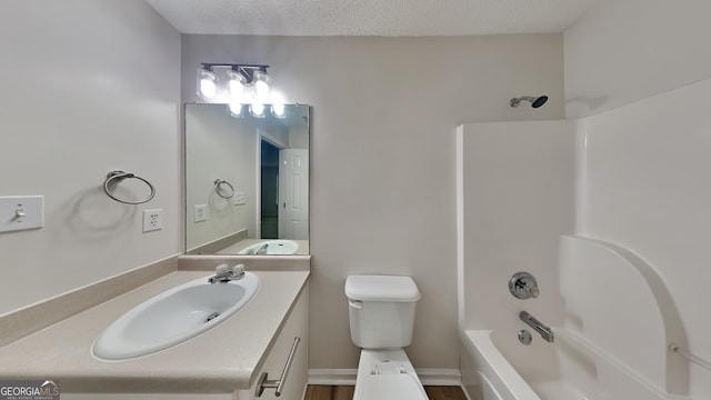 700 Patriots Point St, Locust Grove, GA 30248 - bathroom with vanity, toilet, a textured ceiling, and shower / tub combination