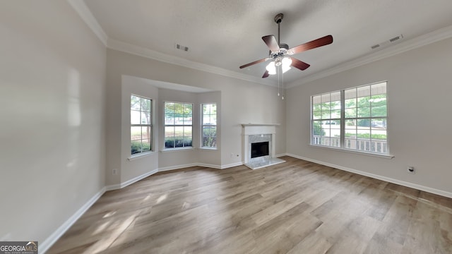 700 Patriots Point St, Locust Grove, GA 30248 - unfurnished living room with wood finished floors, ornamental molding, a premium fireplace, baseboards, and ceiling fan