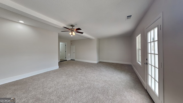 700 Patriots Point St, Locust Grove, GA 30248 - carpeted empty room with baseboards, plenty of natural light, a ceiling fan, and a textured ceiling