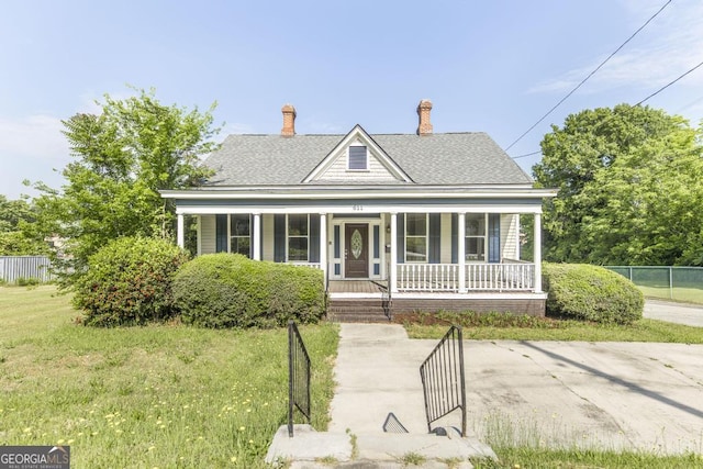 611 Monroe St, Macon, GA 31201 - view of front of home with covered porch, roof with shingles, and a chimney