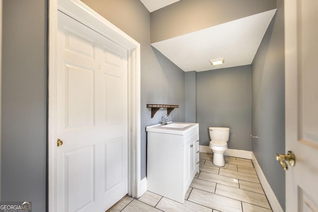 611 Monroe St, Macon, GA 31201 - bathroom with toilet, vanity, and baseboards