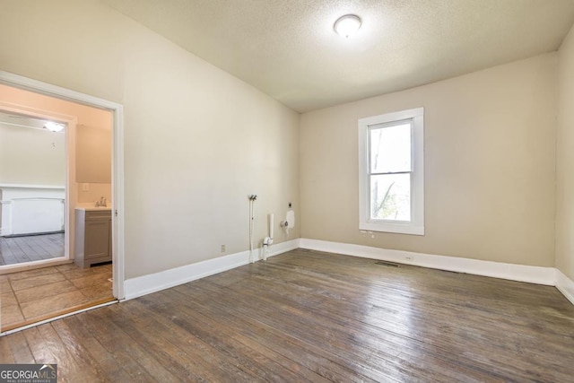 611 Monroe St, Macon, GA 31201 - unfurnished room featuring wood-type flooring, baseboards, and a textured ceiling