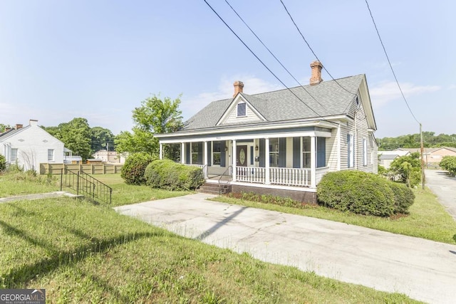 611 Monroe St, Macon, GA 31201 - view of front of house featuring covered porch, a chimney, and roof with shingles