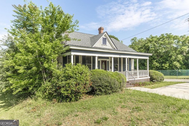 611 Monroe St, Macon, GA 31201 - view of side of home with a shingled roof, covered porch, and a chimney