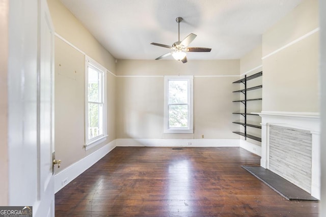 611 Monroe St, Macon, GA 31201 - unfurnished living room with wood-type flooring, ceiling fan, baseboards, and a fireplace