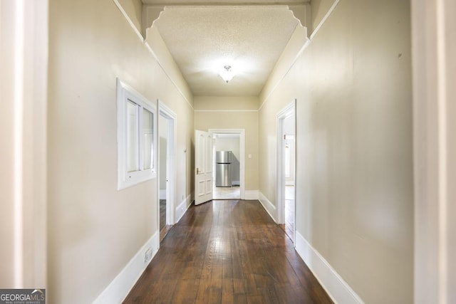 611 Monroe St, Macon, GA 31201 - corridor featuring dark wood-style flooring, baseboards, and a textured ceiling