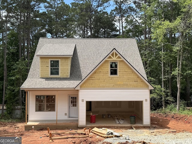 view of front of house featuring roof with shingles and a garage