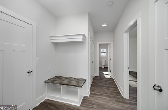 mudroom with dark wood-style floors and baseboards