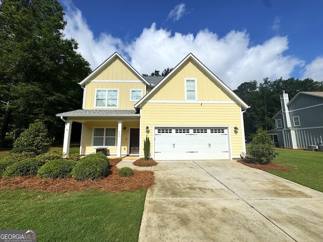 craftsman-style home with concrete driveway, board and batten siding, a front lawn, a porch, and an attached garage