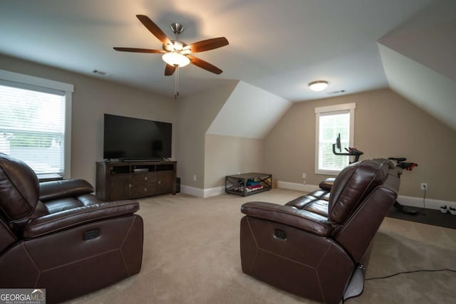 carpeted living area with lofted ceiling, a ceiling fan, and baseboards