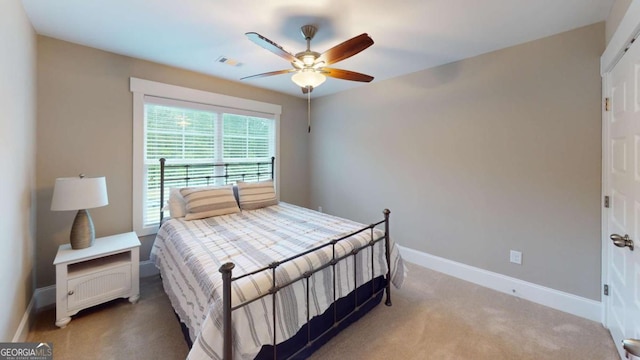 carpeted bedroom featuring baseboards and ceiling fan