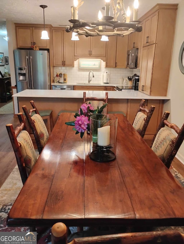 dining room with a chandelier and wood finished floors