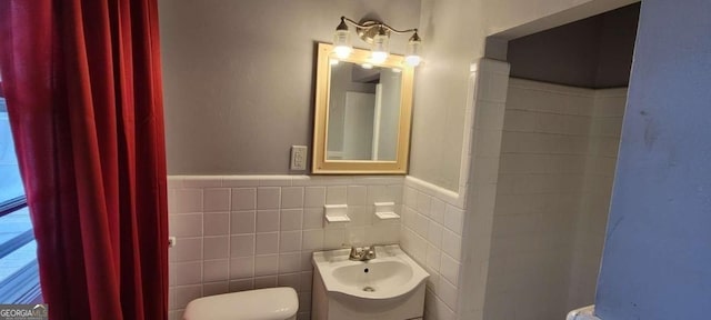 1254 NE Woodland Rd, Conyers, GA 30012 - half bath featuring toilet, a sink, wainscoting, and tile walls