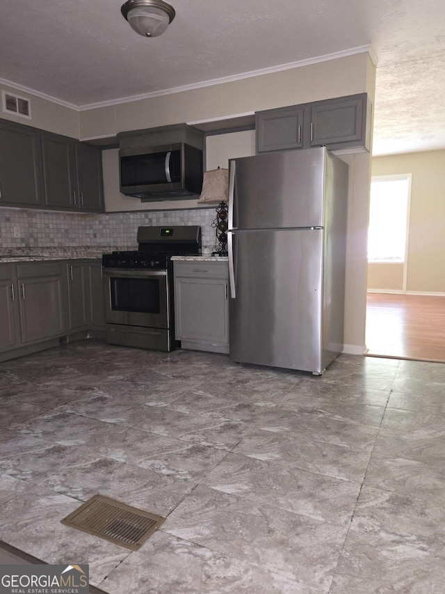 6136 Holiday Blvd, Forest Park, GA 30297 - kitchen with stainless steel appliances, tasteful backsplash, ornamental molding, baseboards, and gray cabinetry
