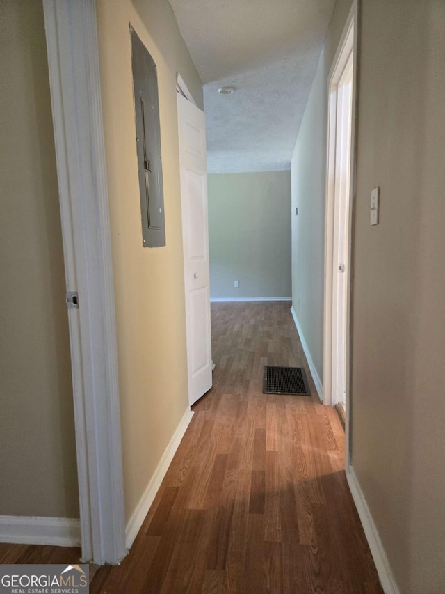 6136 Holiday Blvd, Forest Park, GA 30297 - hall with electric panel, wood finished floors, and baseboards