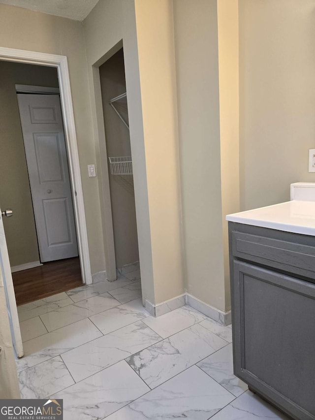 6136 Holiday Blvd, Forest Park, GA 30297 - bathroom with marble finish floors, baseboards, and vanity