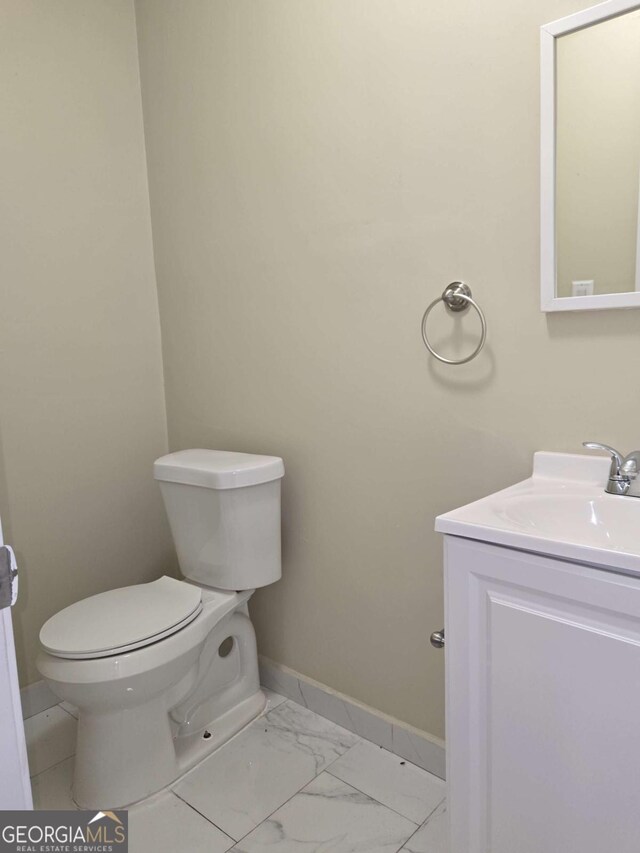6136 Holiday Blvd, Forest Park, GA 30297 - half bath featuring baseboards, marble finish floors, toilet, and vanity