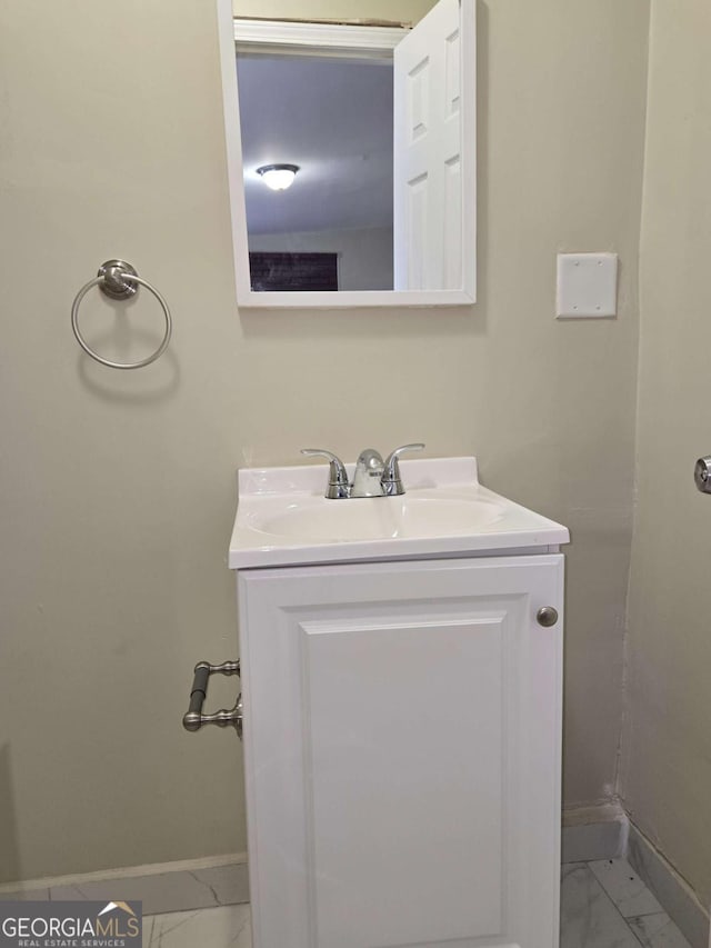 6136 Holiday Blvd, Forest Park, GA 30297 - bathroom featuring baseboards, marble look tiles, and vanity