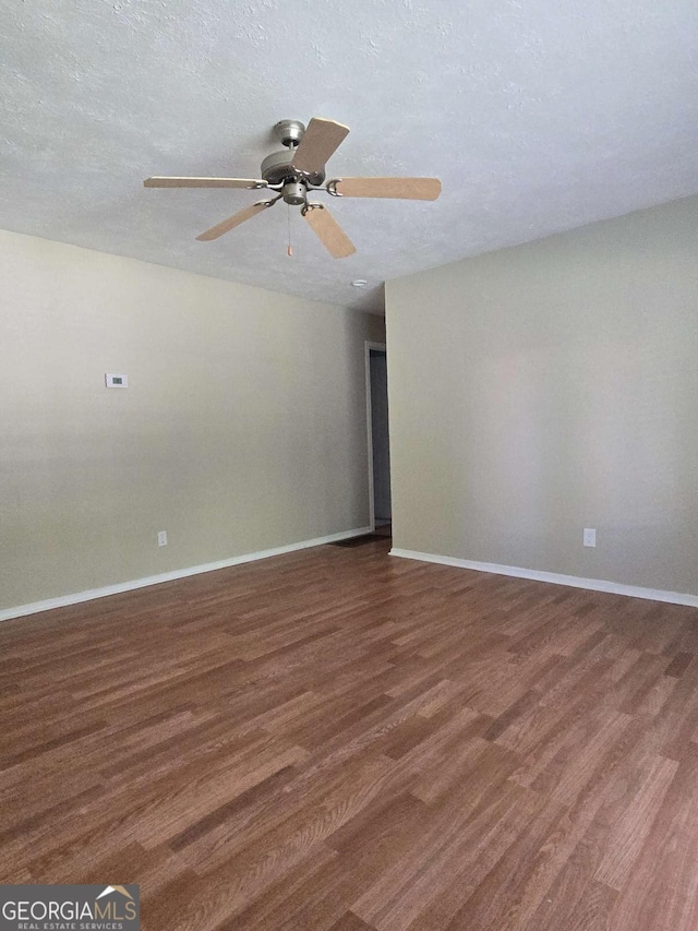 6136 Holiday Blvd, Forest Park, GA 30297 - unfurnished room with wood finished floors, a ceiling fan, baseboards, and a textured ceiling