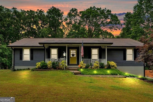 ranch-style home with covered porch and a front yard