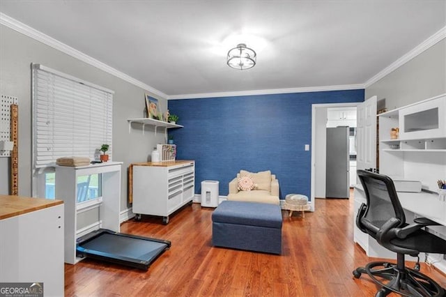 office with an accent wall, wood finished floors, ornamental molding, and baseboards