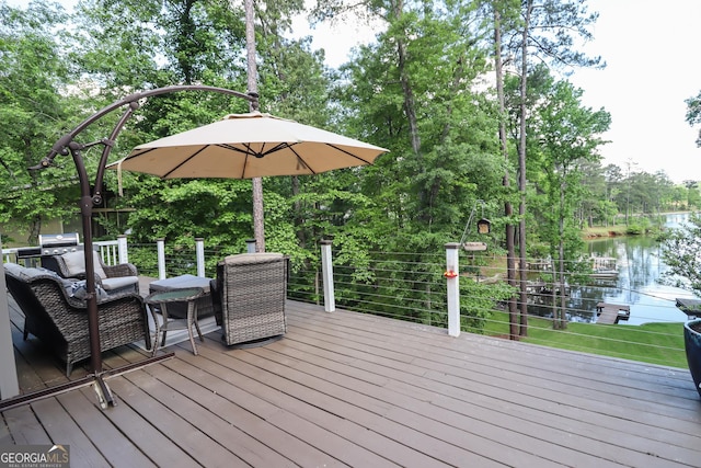 wooden terrace featuring a water view