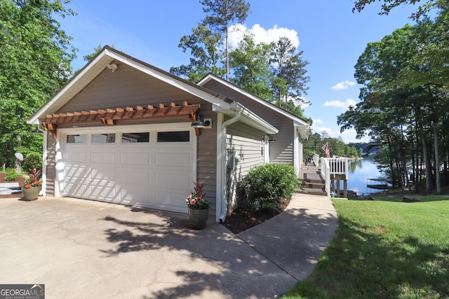view of property exterior with a lawn, a water view, and a garage
