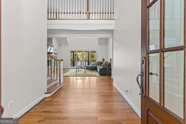 1221 Cosby Cir, Greensboro, GA 30642 - entryway with stairway, baseboards, and light wood-style floors