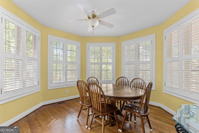 1221 Cosby Cir, Greensboro, GA 30642 - dining room with wood finished floors, baseboards, and a ceiling fan