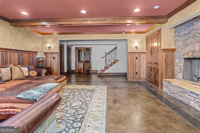 1221 Cosby Cir, Greensboro, GA 30642 - living room featuring ornamental molding, a wainscoted wall, a stone fireplace, stairs, and recessed lighting