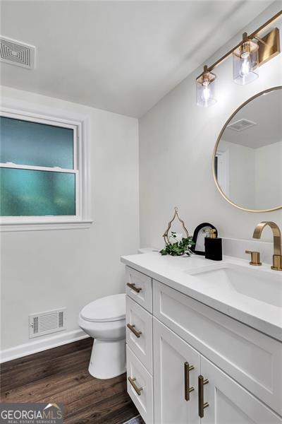 529 Greystone Trl, Marietta, GA 30068 - bathroom featuring vanity, wood finished floors, toilet, and baseboards