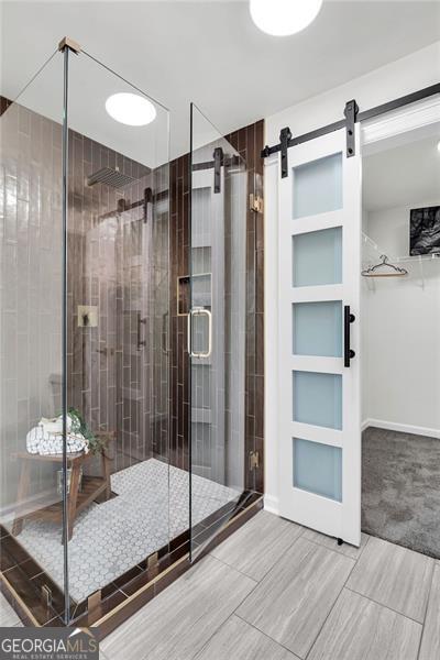 529 Greystone Trl, Marietta, GA 30068 - full bathroom featuring a shower stall, wood tiled floors, and a walk in closet