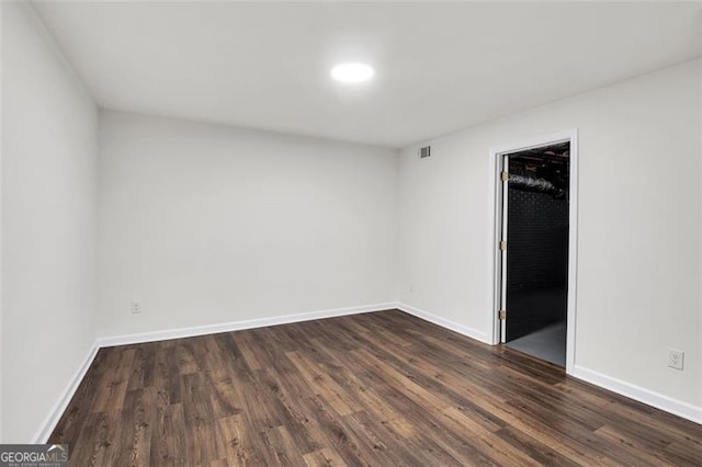 529 Greystone Trl, Marietta, GA 30068 - unfurnished bedroom featuring dark wood-style flooring, baseboards, and a spacious closet