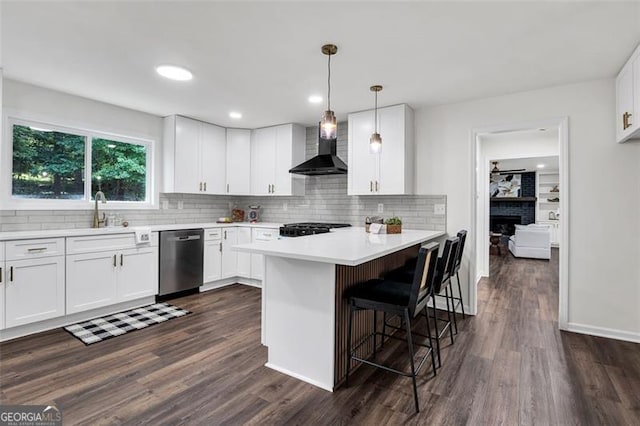 529 Greystone Trl, Marietta, GA 30068 - kitchen featuring dishwasher, wall chimney exhaust hood, a breakfast bar area, backsplash, and light countertops