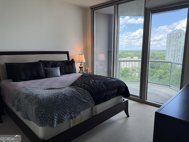 carpeted bedroom featuring a wall of windows and access to exterior