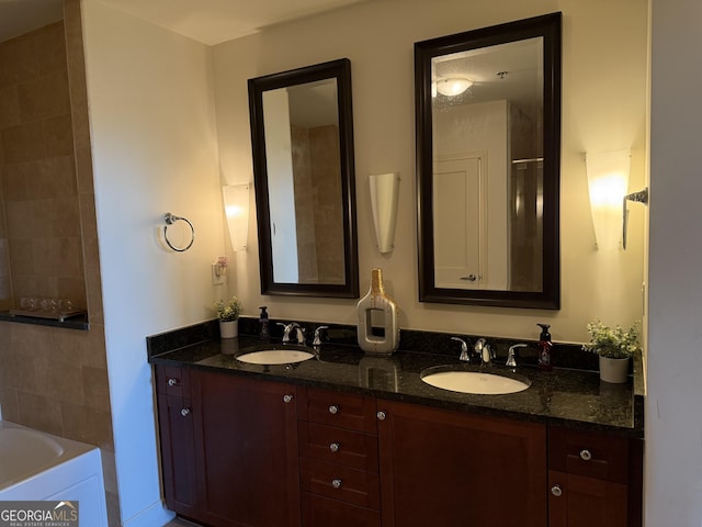 full bathroom featuring double vanity and a tub