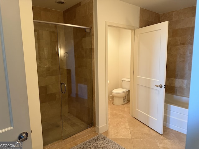full bathroom featuring a shower stall, tile patterned floors, toilet, and a bath