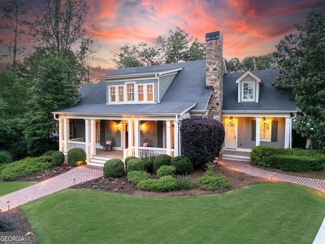 11660 Crabapple Rd, Roswell, GA 30075 - view of front of property with covered porch, a front yard, and a chimney