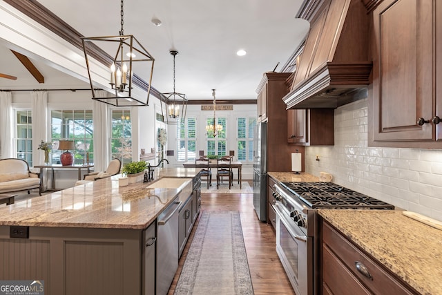 11660 Crabapple Rd, Roswell, GA 30075 - kitchen featuring appliances with stainless steel finishes, premium range hood, a center island with sink, decorative backsplash, and a chandelier