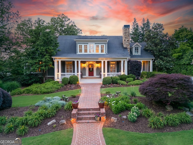 11660 Crabapple Rd, Roswell, GA 30075 - view of front of house with covered porch, a chimney, and a lawn