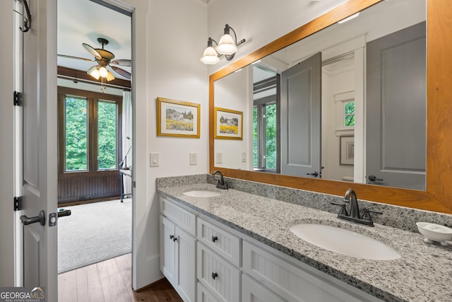 11660 Crabapple Rd, Roswell, GA 30075 - bathroom featuring plenty of natural light, double vanity, a ceiling fan, wood finished floors, and crown molding
