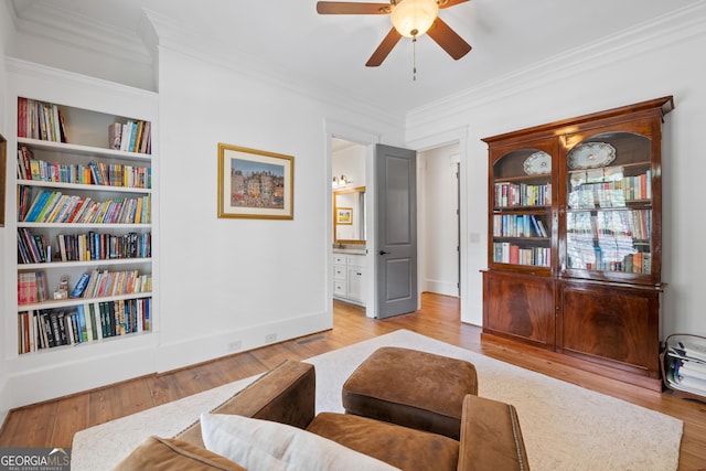11660 Crabapple Rd, Roswell, GA 30075 - living area featuring crown molding, light wood-style flooring, a ceiling fan, and built in features