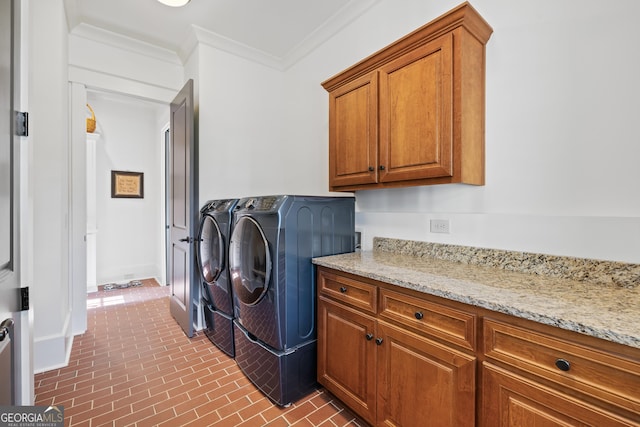 11660 Crabapple Rd, Roswell, GA 30075 - laundry room featuring washing machine and dryer, cabinet space, ornamental molding, and brick patterned floors