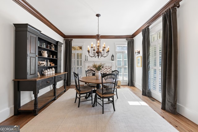 11660 Crabapple Rd, Roswell, GA 30075 - dining area featuring a chandelier, crown molding, and light wood-style flooring