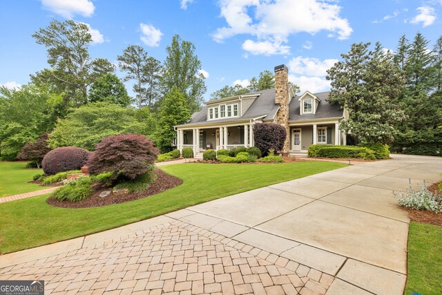 11660 Crabapple Rd, Roswell, GA 30075 - view of front facade with a front lawn, covered porch, driveway, and a chimney